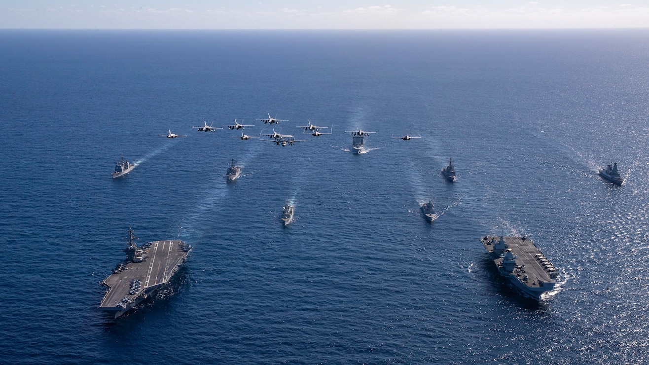 U.S. Navy aircraft, attached to Carrier Air Wing (CVW) 5, fly over U.S. Navy George Washington Carrier Strike Group, as it participates in dual carrier operations alongside Royal Navy HMS Prince of Wales Carrier Strike Group while underway in the Timor Sea, as part of Talisman Sabre, July 18, 2025.