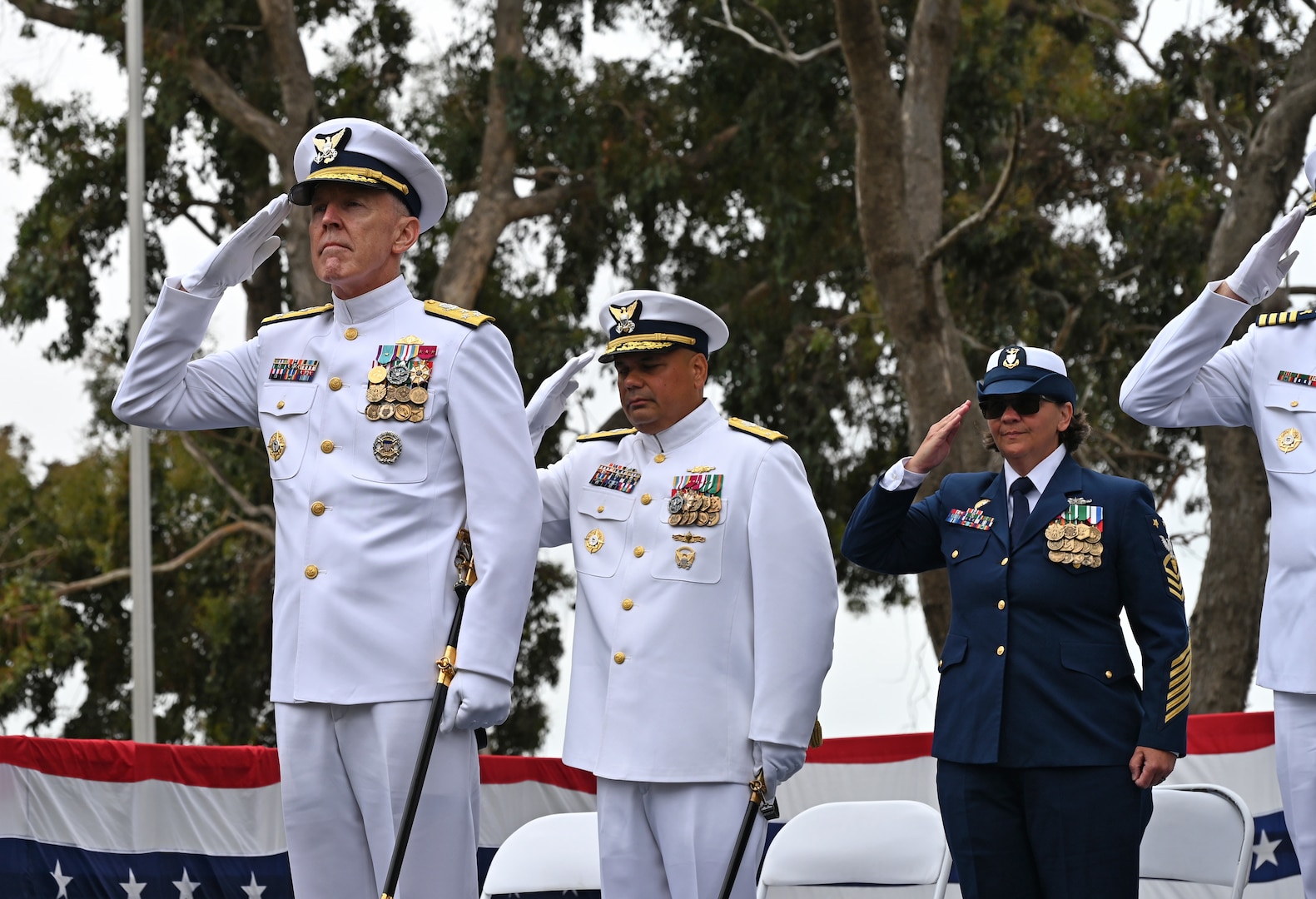The official party salutes the American flag during a retirement ceremony held at Coast Guard Base Alameda, California, July 18, 2025. Adm. Kevin Lunday, the Coast Guard’s acting commandant, presided over the ceremony in which Vice Adm. Andrew Tiongson, commander, U.S. Coast Guard Pacific Area, retired following 40 years of honorable service. (U.S. Coast Guard photo by Petty Officer 3rd Class Joel LaVallee)