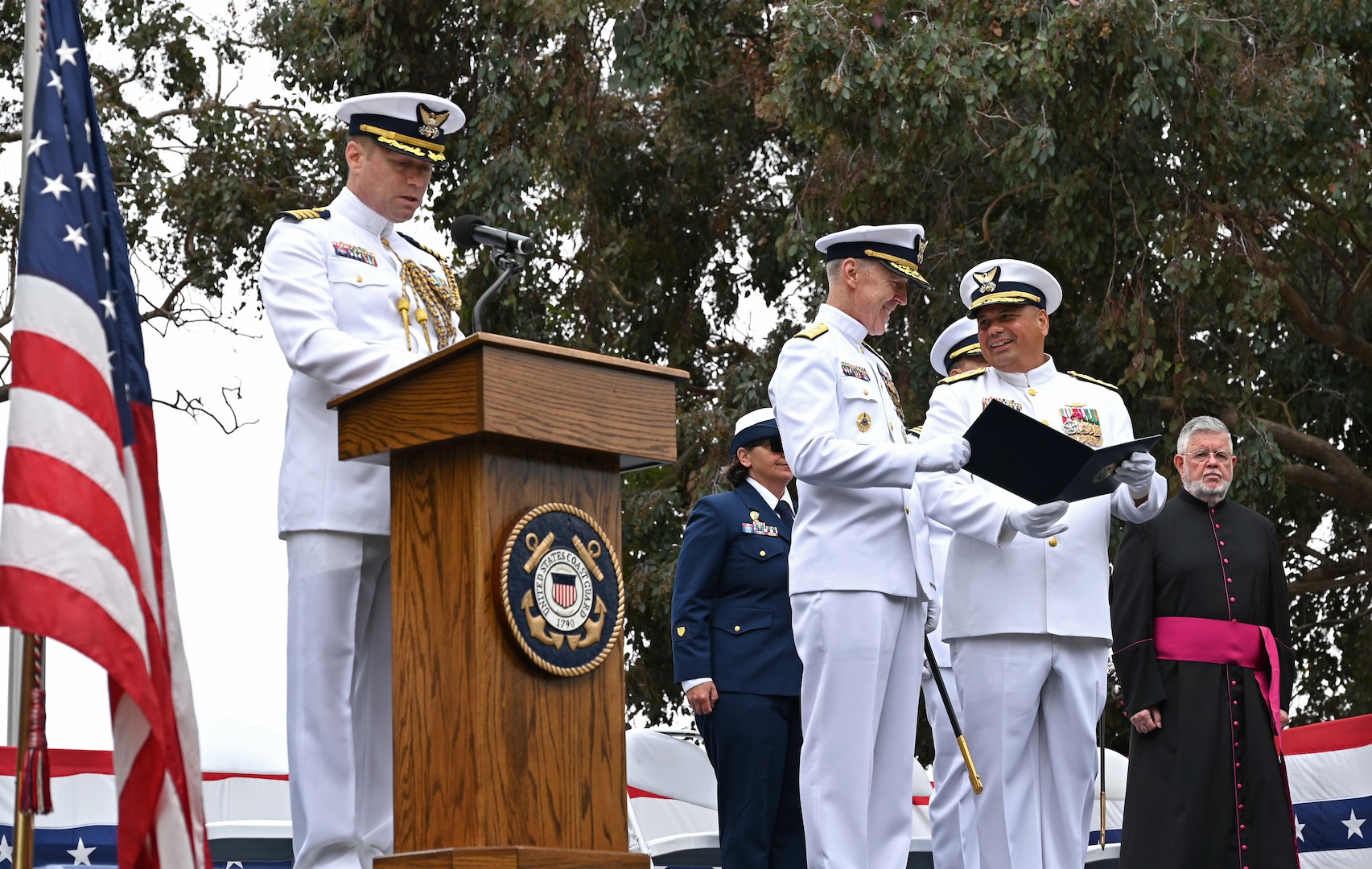 Vice Adm. Andrew Tiongson, commander, U.S. Coast Guard Pacific Area, is presented an award by Adm. Kevin Lunday, the Coast Guard’s acting commandant at Coast Guard Base Alameda, California, July 18, 2025. Lunday, presided over the ceremony in which Tiongson retired following 40 years of honorable service. (U.S. Coast Guard photo by Petty Officer 3rd Class Joel LaVallee)