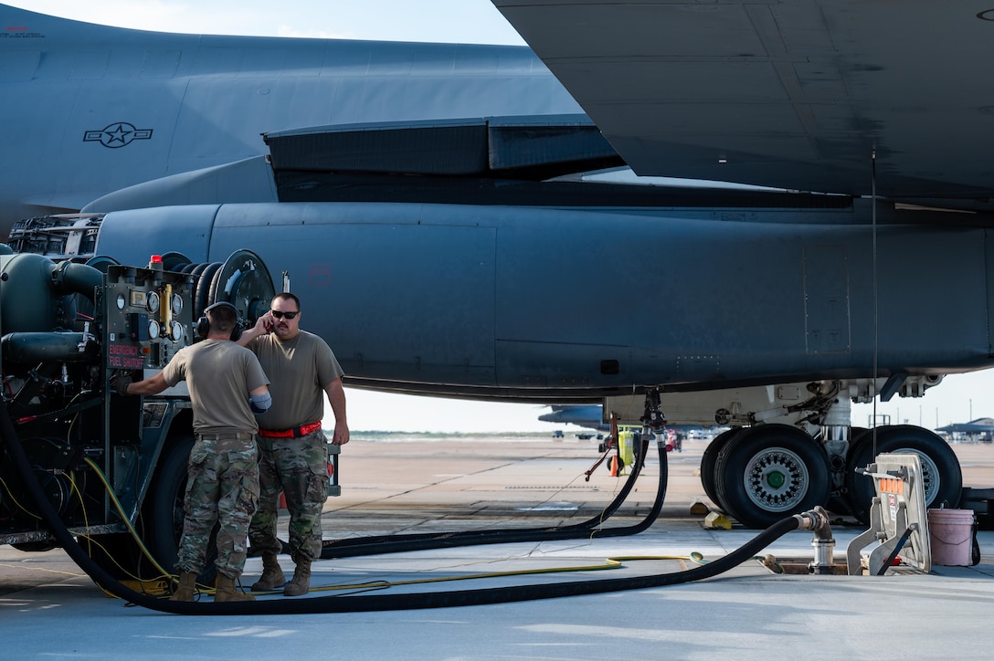 U.S. Air Force Airmen assigned to the 7th Logistics Readiness Squadron perform a hot pit refuel on a B-1B Lancer at Dyess Air Force Base, Texas, July 8, 2025. Hot pit refueling is a rapid ground refueling method in which aircraft are serviced immediately after landing with engines still running, allowing aircrews to relaunch without shutting down. (U.S. Air Force photo by Airman 1st Class Adrien Tran)