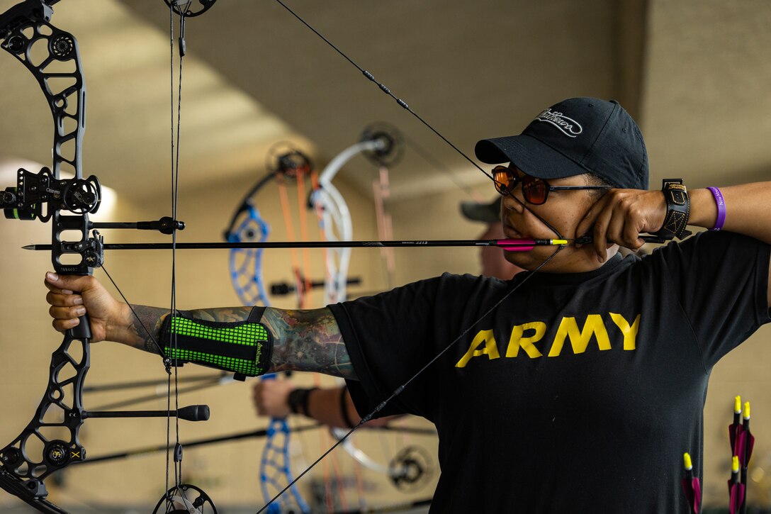 U.S. Army Capt. Channda Mitchell draws her compound bow while participating in archery practice during the 2025 Department of Defense Warrior Games at Fort Carson,