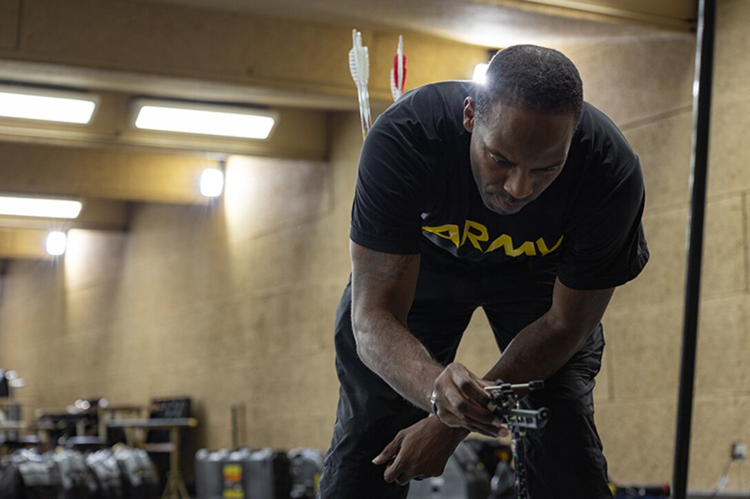 U.S. Army Staff Sgt. Derrick Thompson adjusts the site on his bow while participating in archery practice during the 2025 Department of Defense Warrior Games at Fort Carson, Colorado, July 13, 2025.