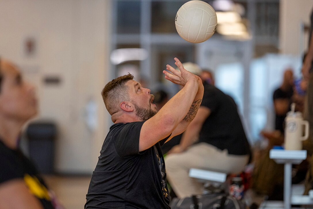 U.S. Army Sgt. 1st Class Adam Proctor prepares to hit the ball while conducting drills at sitting volleyball practice during the 2025 Department of Defense Warrior Games at Fort Carson, Colorado, July 13, 2025.