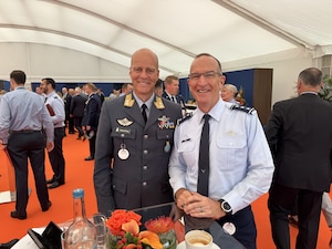 Two men pose for a photo