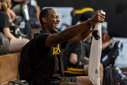 U.S. Army Staff Sgt. Derrick Thompson holds up the shirt as part of the new Team Army uniform at the 2025 Department of Defense Warrior Games at Colorado Springs, Colorado, July 15, 2025.