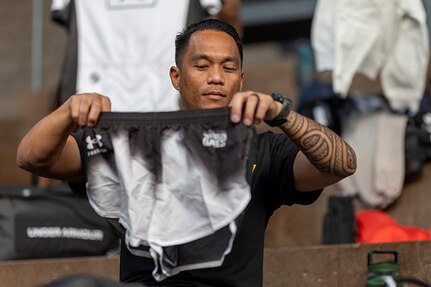 U.S. Army Staff Sgt. Nathaniel Mateo checks out part of his new Team Army uniform during the 2025 Department of Defense Warrior Games at Colorado Springs, Colorado, July 15, 2025.