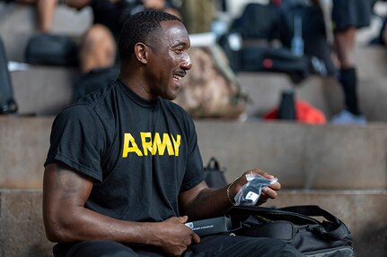 U.S. Army Master Sgt. Earlie Brown jokes with a teammate at the Team Army uniform issue during the 2025 Department of Defense Warrior Games at Colorado Springs, Colorado, July 15, 2025.