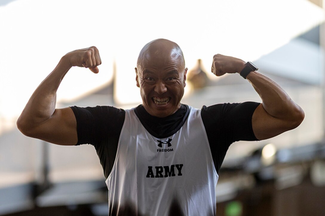 U.S. Army Sgt. 1st Class David Hong performs a flex pose in his new Team Army track shirt during the 2025 Department of Defense Warrior Games at Colorado Springs, Colorado, July 15, 2025.