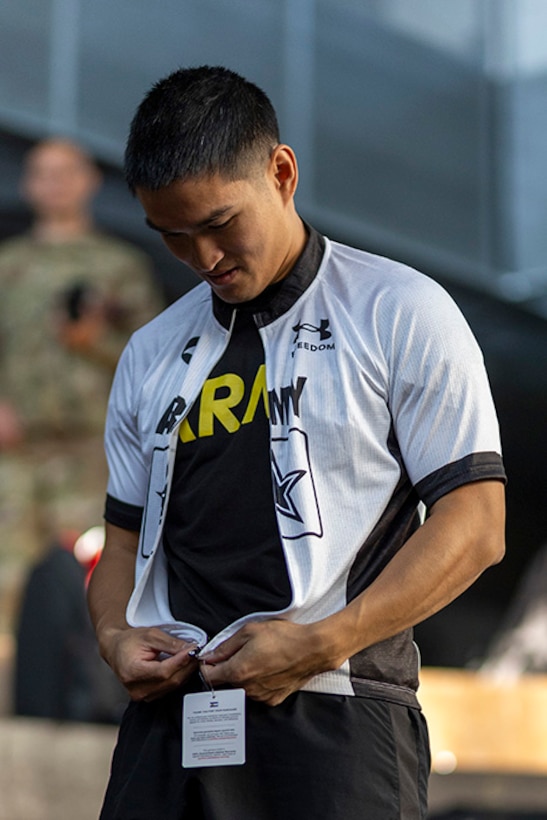 U.S. Army Staff Sgt. Tam Hoang tries on part of his new Team Army uniform during the 2025 Department of Defense Warrior Games at Colorado Springs, Colorado, July 15, 2025.