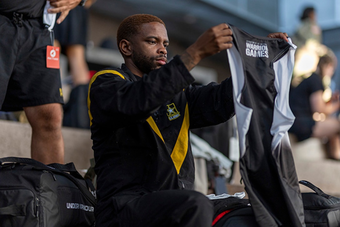 U.S. Army Staff Sgt. Allaijah Churchwell checks out part of his new Team Army uniform during the 2025 Department of Defense Warrior Games at Colorado Springs, Colorado, July 15, 2025.