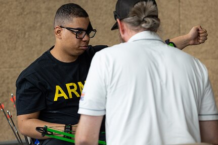 U.S. Army Spc. Colby Maury-Rice gets instructions from a coach while participating in archery practice during the 2025 Department of Defense Warrior Games practice sessions at Fort Carson, Colorado, July 13, 2025.