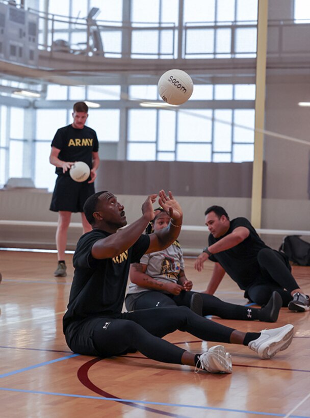 U.S. Army Master Sgt. Earlie Brown prepares to set the ball at sitting volleyball practice during the 2025 Department of Defense Warrior Games training camp at Fort Carson, Colorado, July 15, 2025.