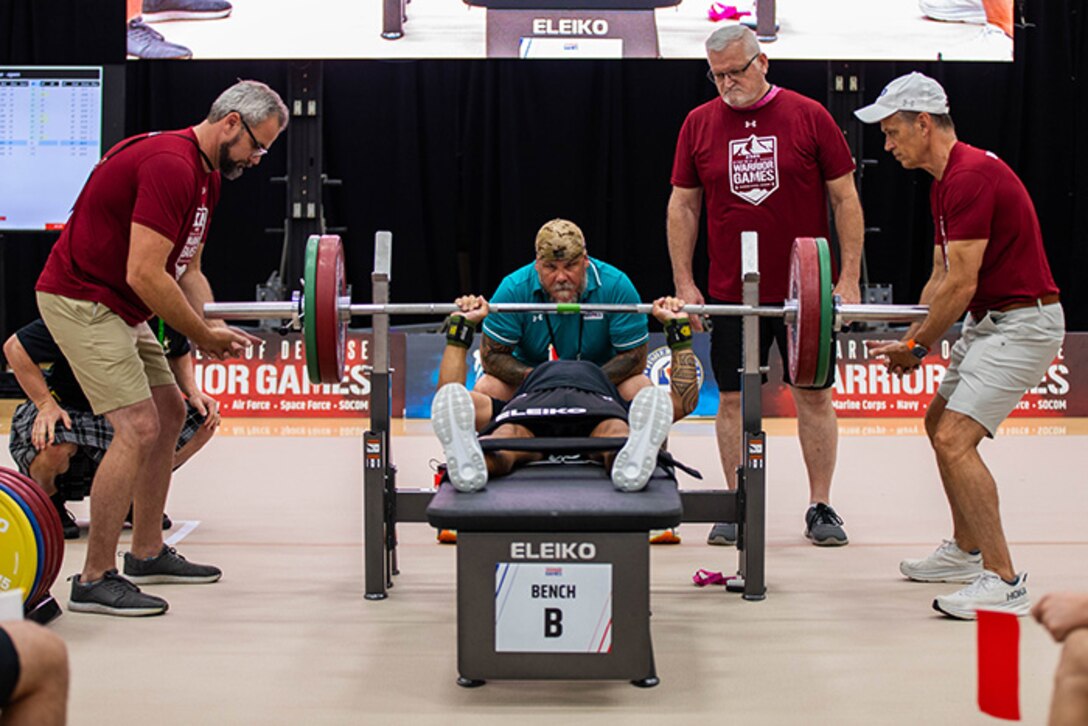 U.S. Army Staff Sgt. Nathaniel “Nate” Mateo pushes up his first rep for the powerlifting event during the 2025 Department of Defense Warrior Games at Reid Arena, Colorado Springs, Colorado, July 18, 2025.