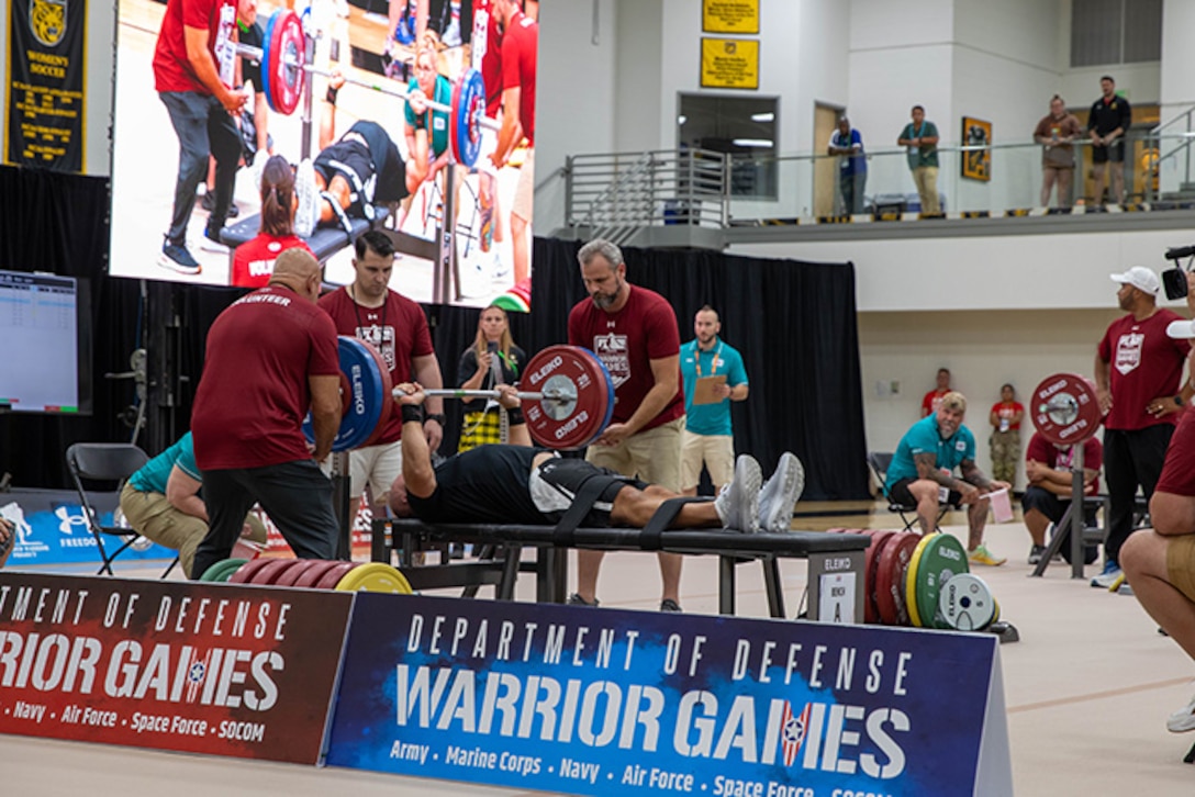 U.S. Army 1st Sgt. Christopher Morago works hard to complete his rep at the powerlifting event during the 2025 Department of Defense Warrior Games at Reid Arena, Colorado Springs, Colorado, July 18, 2025.