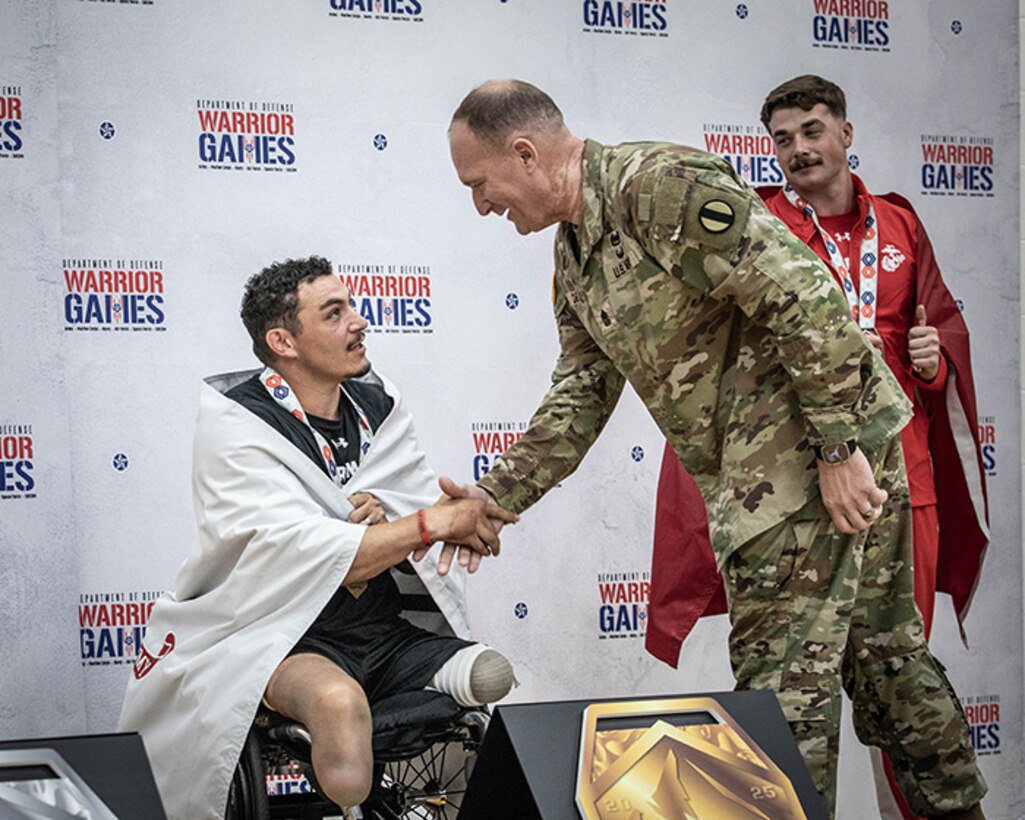 U.S. Army Veteran, Sgt. Jason Smith, left, is awarded the gold medal by Sgt. Maj. Christopher Carey, the Deputy Chief of Staff Sergeant Major, U.S. Army Training and Doctrine Command.