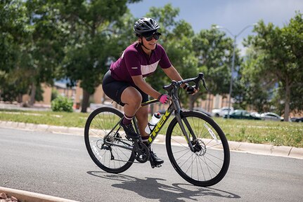 U.S. Army Staff Sgt. Mercedes Rangel leans into a turn at cycling training camp during the 2025 Department of Defense Warrior Games training camp at Fort Carson, Colorado, July 15, 2025.