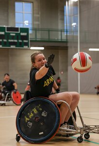 U.S. Army Capt. Samantha Frey reaches for the ball while participating in drills at wheelchair rugby practice during the 2025 Department of Defense Warrior Games training camp at Fort Carson, Colorado, July 14, 2025.