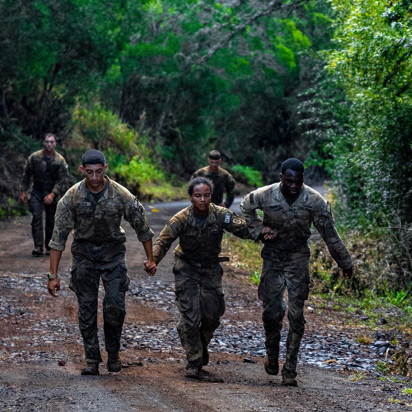 U.S. Army Soldiers assigned to 8th Theater Sustainment Command conduct a 12-mile road march during the U.S. Army Pacific Best Squad Competition, July 15, 2025, at Bellows Training Area, Hawaii.