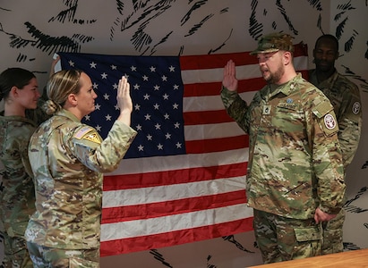 U.S. Army Maj. Casey Turner, left, listens as Sgt. 1st Class Adam Proctor recites back the oath of enlistment at his re-enlistment ceremony during the 2025 Department of Defense Warrior Games at Colorado Springs, Colorado, July 18, 2025.