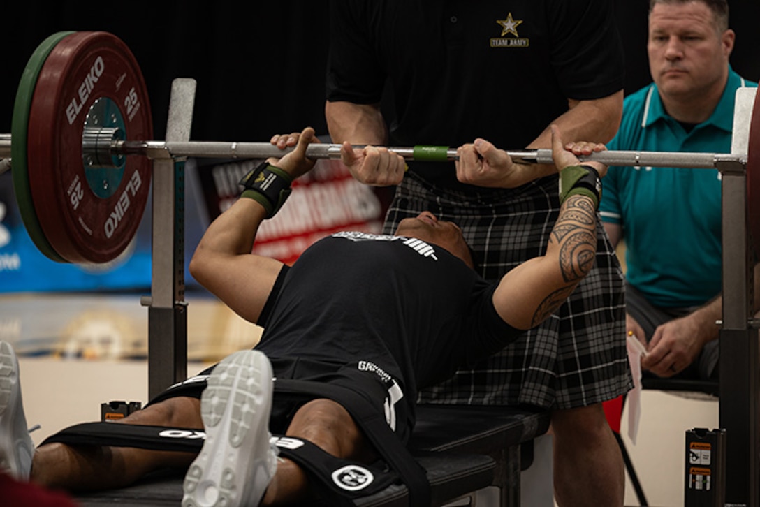 U.S. Army Staff Sgt. Nathaniel Mateo arches his back to give himself more support before competing in the powerlifting competition at the 2025 Department of Defense Warrior Games at Colorado Springs, Colorado, July 18, 2025.