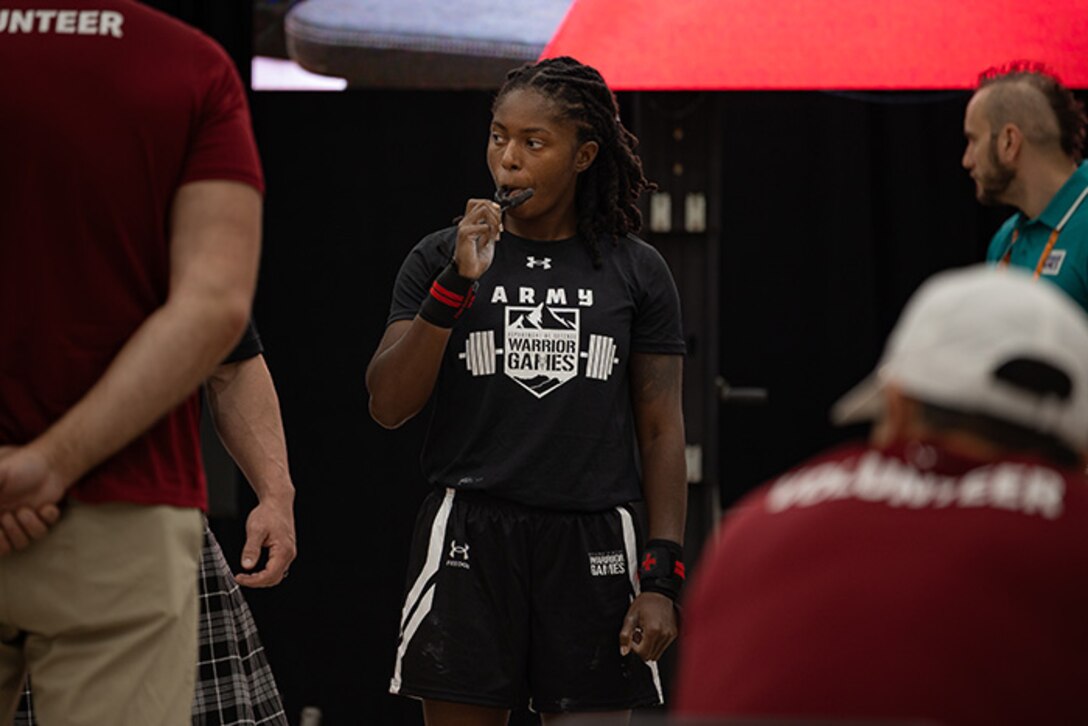 U.S. Army 1st Lt. Jani Merritt puts in her mouth guard before participating in the powerlifting competition during the 2025 Department of Defense Warrior Games at Colorado Springs, Colorado, July 18, 2025.