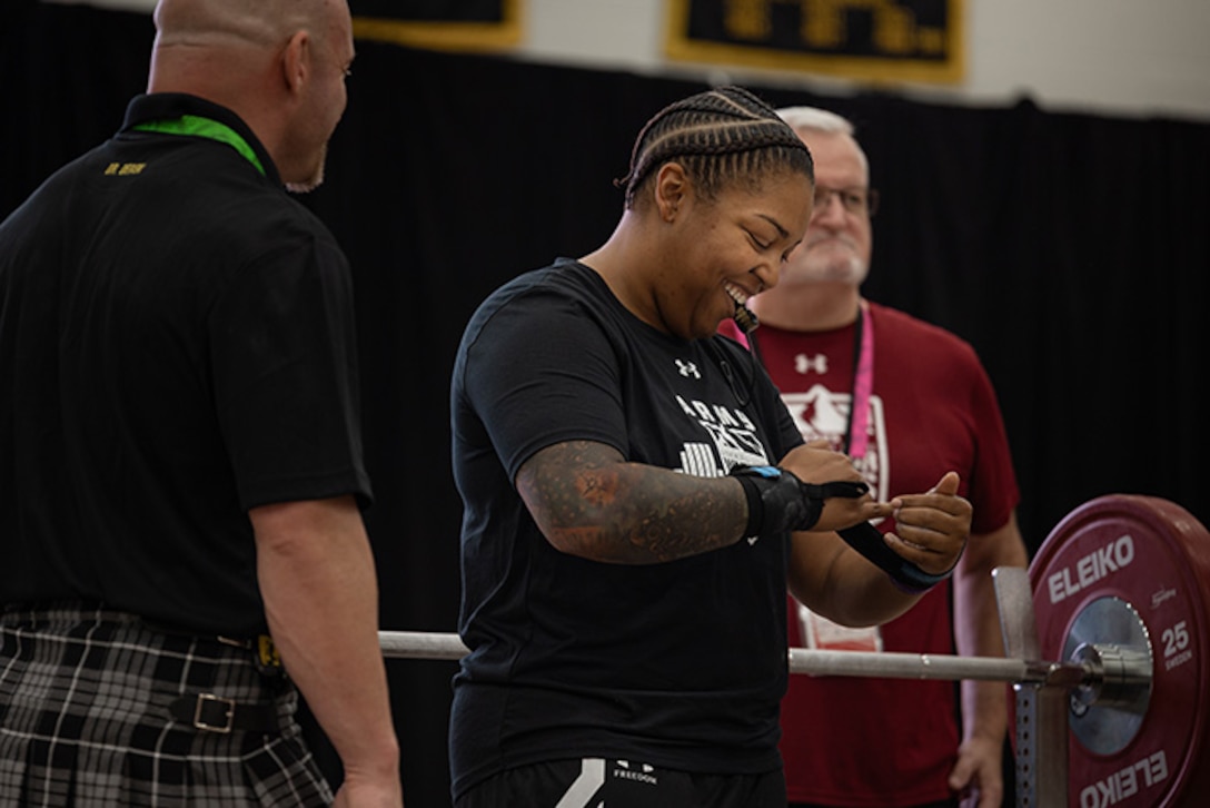 U.S. Army Capt. Channda Mitchell tightens her wrist straps before participating in the powerlifting competition during the 2025 Department of Defense Warrior Games at Colorado Springs, Colorado, July 18, 2025.