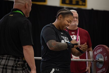 U.S. Army Capt. Channda Mitchell tightens her wrist straps before participating in the powerlifting competition during the 2025 Department of Defense Warrior Games at Colorado Springs, Colorado, July 18, 2025.