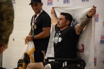 U.S. Army Retired Sgt. Jason Smith poses with the Army flag at the medal ceremony before being awarded the gold medal at the powerlifting competition during the 2025 Department of Defense Warrior Games at Colorado Springs, Colorado, July 18, 2025.