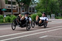 U.S. Army Sgt. 1st Class Jeffery Peters, front, and 1st Sgt. Christopher Morago compete in the recumbent cycling event during the 2025 Department of Defense Warrior Games, Colorado Springs, Colorado, July 19, 2025.