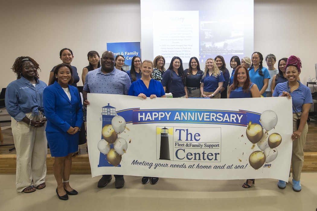 he Commander, Fleet Activities Yokosuka Fleet and Family Support Center (FFSC) staff members posed for a photo during the organization's 46th Anniversary in the Community Readiness Center on Main Base in Yokosuka, Japan.