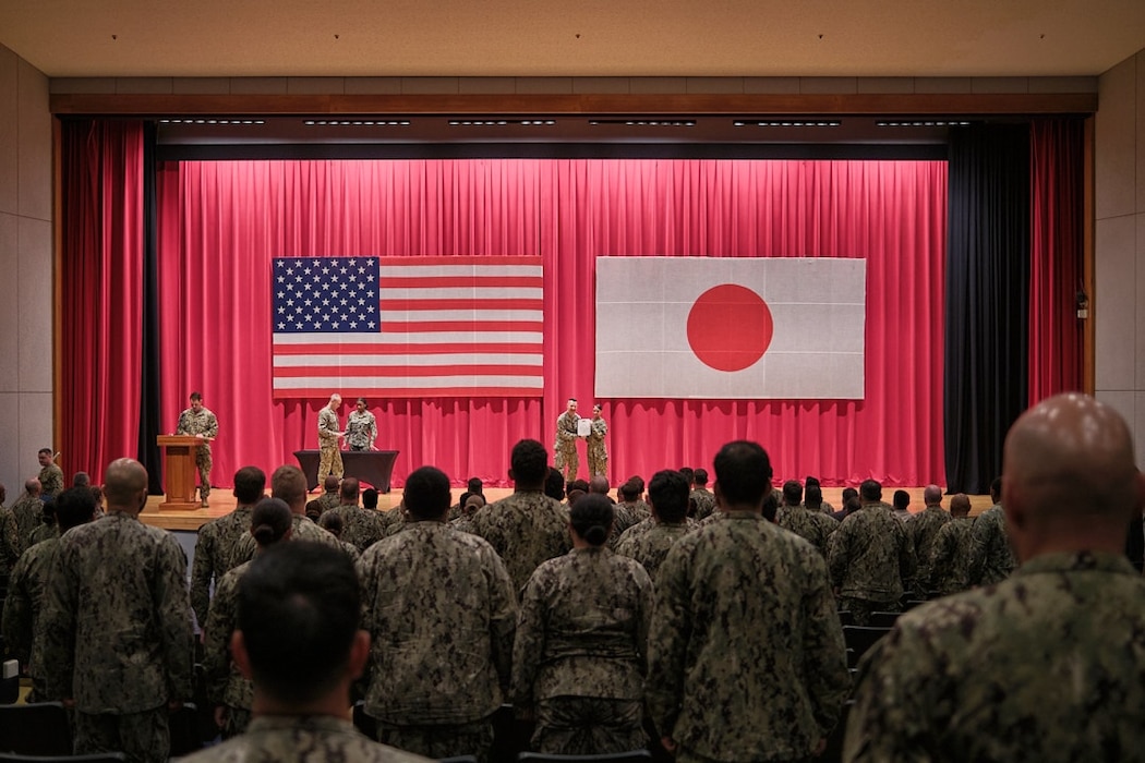Capt. Les Sobol, Commander, Fleet Activities Yokosuka, awards a Letter of Commendation to Machinist's Mate 3rd Class Mckenzie Odell Friday, July 18, 2025 at an All Hands in the Benny Decker Theater.
