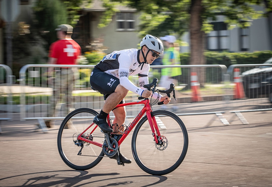 U.S. Army Staff Sgt. Tam Hoang pushes through the initial stretch of the cycling competition in the 2025 Department of Defense Warrior Games, Colorado Springs, Colorado, July 19, 2025.