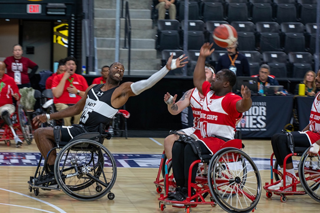 U.S. Army Staff Sgt. Derrick Thompson attempts to steal the ball from U.S. Marine Corps Cpl. Dimitri Cheuko during wheelchair basketball at the 2025 Department of Defense Warrior Games in Colorado Springs, Colorado, July 19, 2025.