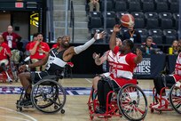 U.S. Army Staff Sgt. Derrick Thompson attempts to steal the ball from U.S. Marine Corps Cpl. Dimitri Cheuko during wheelchair basketball at the 2025 Department of Defense Warrior Games in Colorado Springs, Colorado, July 19, 2025.