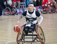 U.S. Army Retired Spc. JP Lane dribbles the ball down court during a wheelchair basketball game at the 2025 Department of Defense Warrior Games at Ed Robson Arena in Colorado Springs, Colorado, July 19, 2025.