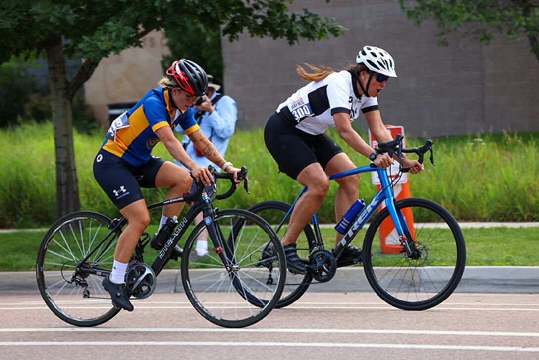 U.S. Army Maj. Sherri Saunders holds her position against a Team Navy athlete in the women's upright bicycle road race during the cycling event, July 19, at the Colorado College, Colorado Springs, Colorado.