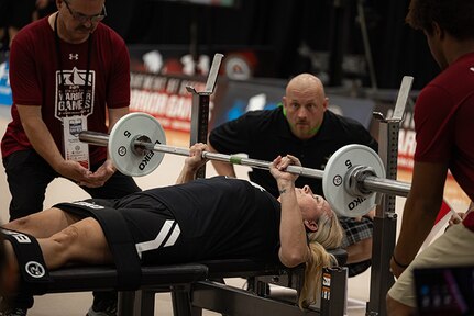 U.S. Army Maj. Amy Sparks pushes up on the barbell to complete her bench press during powerlifting at the 2025 Department of Defense Warrior Games at Colorado Springs, Colorado, July 18, 2025.