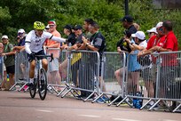 U.S. Army Sgt. 1st Class David Hong reaches out to a spectator before crossing the finish line in the men's upright bicycle road race at the cycling event during the 2025 Department of Defense Warrior Games at Colorado College, Colorado Springs Colorado, July 19, 2025.