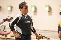 U.S. Army Chief Warrant Officer 4 Joan Tsuhako prepares to fire an air pistol during shooting practice at the 2025 Department of Defense Warrior Games in Colorado Springs, Colorado, July 20, 2025.