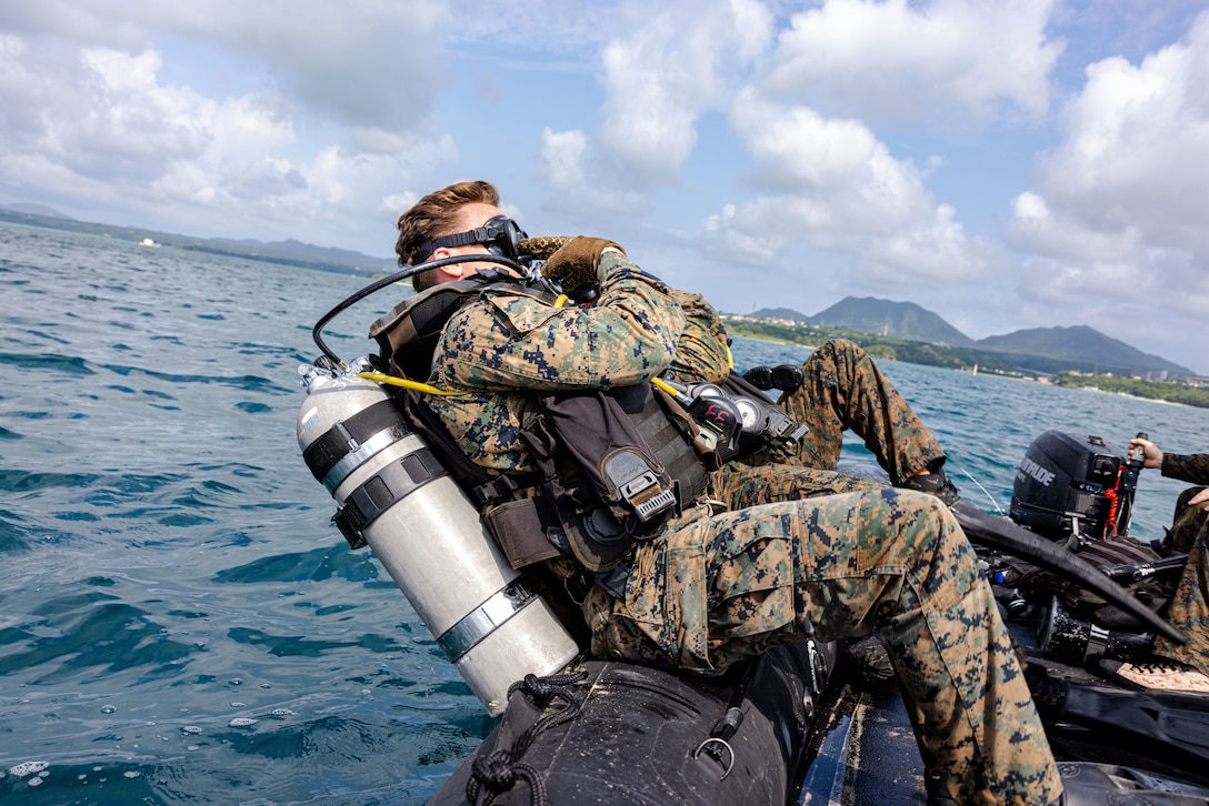 U.S. Marines with 3d Reconnaissance Battalion, 3d Marine Division dive from a Combat Rubber Raiding Craft during a search and recovery drill on Camp Schwab, Okinawa, Japan, July 15, 2025.