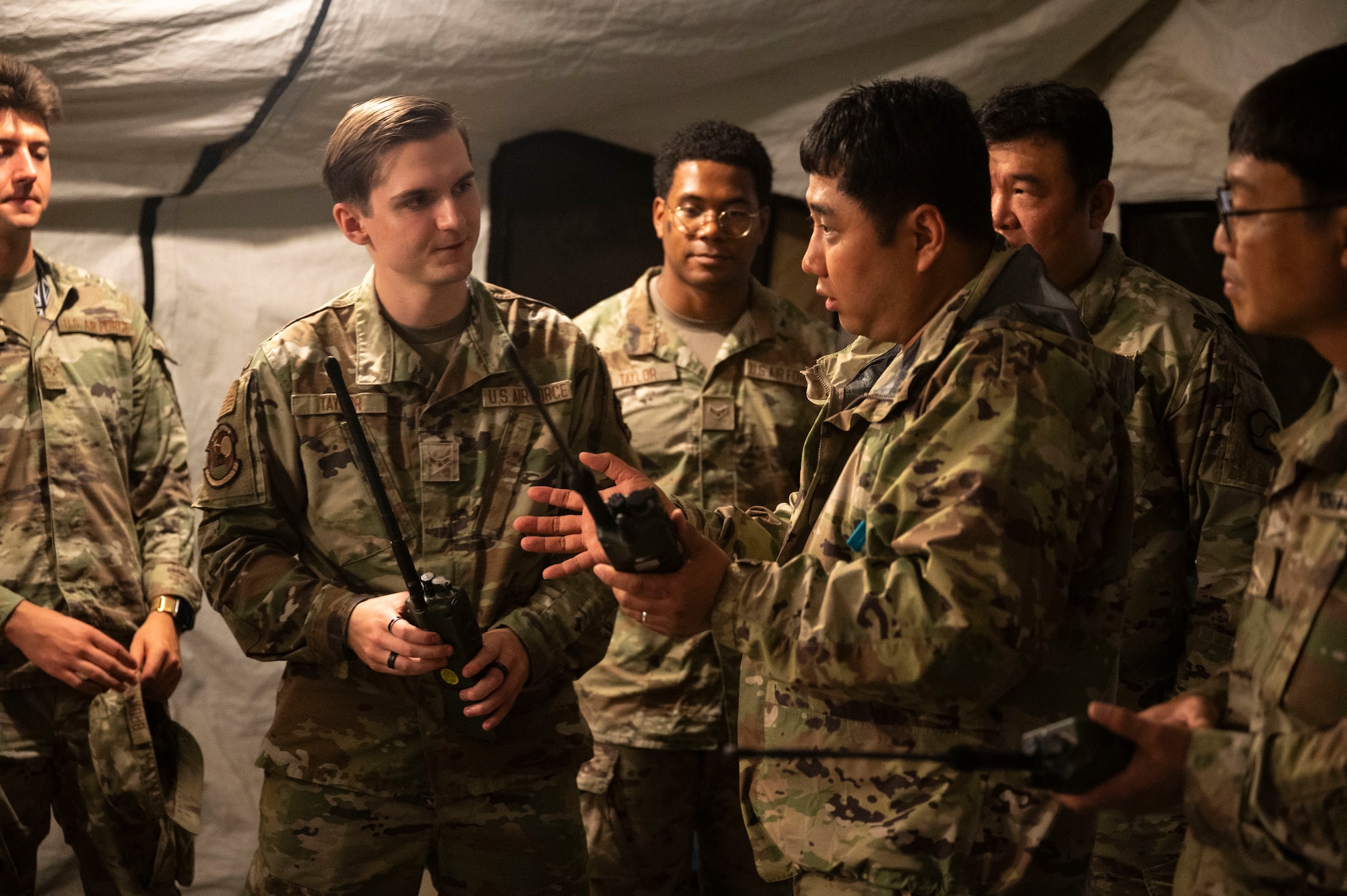 U.S. Airmen assigned to the 51st Communications Squadron brief members of the Korean Service Corps Battalion on equipment vital for hand held  communications at Osan Air Base, Republic of Korea, July 17, 2025.