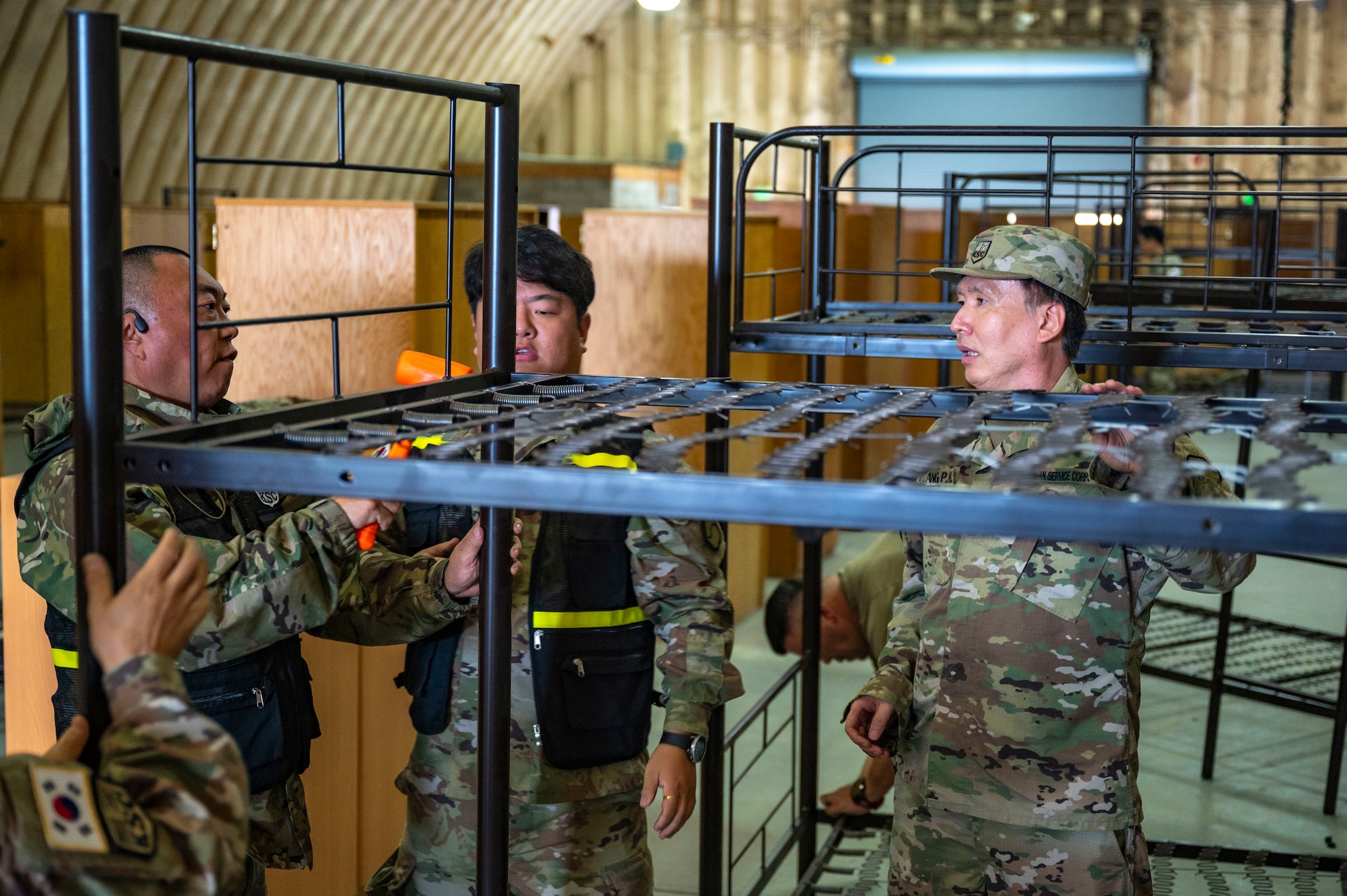 Members of the Korean Service Corps Battalion build bunk beds during a bilateral logistics and transportation training event at Osan Air Base, Republic of Korea, July 17, 2025.
