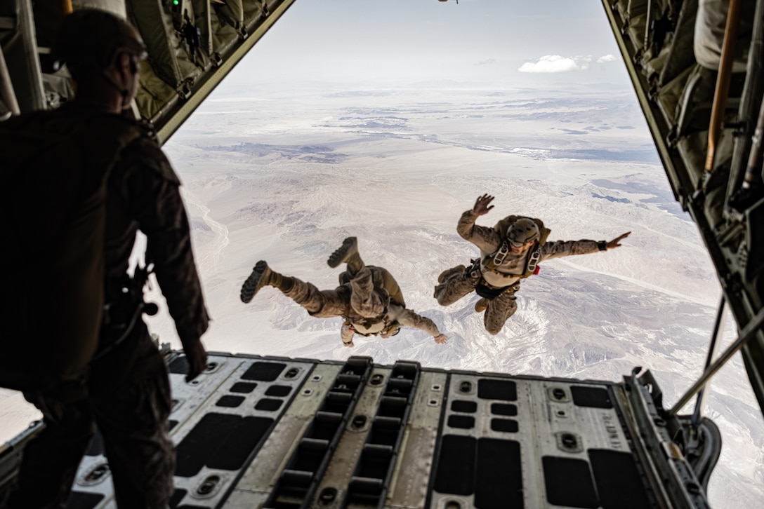 U.S. Marines with 2d Reconnaissance Battalion, 2d Marine Division conduct a freefall jump off a C-130 Hercules during Service Level Training Exercise 4-25, at Marine Corps Air-Ground Combat Center, Twentynine Palms, California, July 17, 2025. SLTE 4-25 is designed to be a challenging, realistic training environment that produces combat-ready forces capable of operating as an integrated Marine Air Ground Task Force across all domains of military operations. (U.S. Marine Corps photo by Lance Cpl. Judith Ann Lazaro)