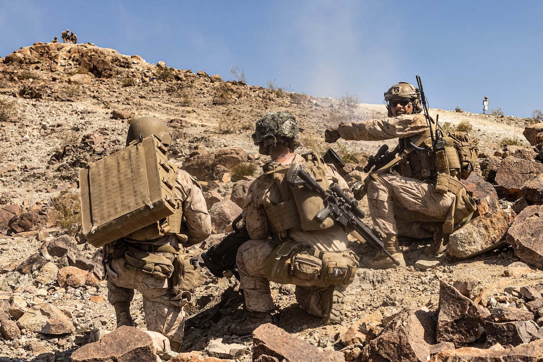 U.S. Marines and Sailors with 2d Battalion, 8th Marines, 2d Marine Regiment, 2d Marine Division conduct a live-fire platoon attack during Service Level Training Exercise 4-25, on Range 410A at Marine Corps Air-Ground Combat Center, Twentynine Palms, California, July 16, 2025. SLTE 4-25 is designed to be a challenging, realistic training environment that produces combat-ready forces capable of operating as an integrated Marine Air Ground Task Force across all domains of military operations. (U.S. Marine Corps photo by Lance Cpl. Judith Ann Lazaro)