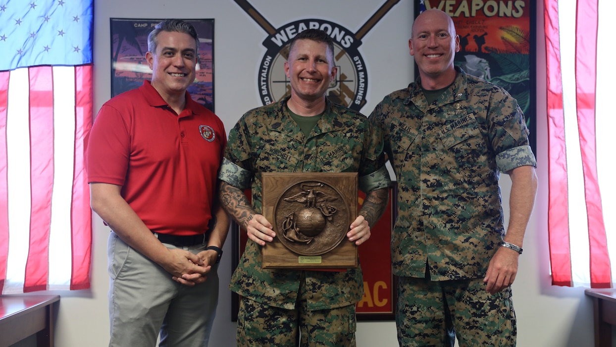 U.S. Marine Corps 1st Sgt. Chad Winchell with 2d Battalion, 8th Marines, 2d Marine Division poses for a photo alongside Lt. Col. William Willis, the commanding officer of 2d Battalion, 8th Marines, 2d Marine Division and a Marine Corps League representative during an award ceremony on Marine Corps Base Camp Lejeune, North Carolina, June 18, 2025. 1st Sgt. Winchell received the Sergeant Major Wilbur Bestwick Award for his outstanding contributions to increased combat readiness throughout the Marine Corps during his 18 years of dedicated service. (U.S. Marine Corps photo by Cpl. Alexander Peterson)