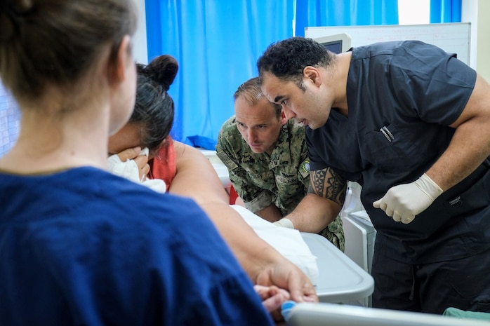 NUKU’ALOFA, Tonga (June 24, 2025) U.S. Navy Lt. Cmdr. Sean Foley, center, Critical Care Physician with Pacific Partnership 2025 (PP-25), and U.S. Navy Lt. Brittany Debow, left, Critical Care Nurse with PP-25, assist Dr. Richard Taumoepeau, a local physician, right, during an ultrasound-guided thoracentesis on a local patient at Vaiola Hospital as part of PP-25 in Nuku’Alofa, Tonga, June 24, 2025. Now in its 21st iteration, the Pacific Partnership series is the largest annual multinational humanitarian assistance and disaster management preparedness mission conducted in the Indo-Pacific. Pacific Partnership works collaboratively with host and partner nations to enhance regional interoperability and disaster response capabilities, increase security and stability in the region, and foster new and enduring friendships in the Indo-Pacific. (U.S. Navy photo by Courtesy Asset/Released)