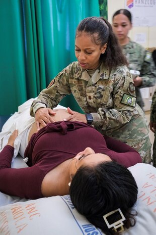 NUKU’ALOFA, Tonga (June 24, 2025) U.S. Army Maj. Tiffany Wilson, center, Nurse Practioner deployed in support of Pacific Partnership 2025 (PP-25), delivers prenatal care to a local patient during a health consultation at Vaiola Hospital as part of PP-25 in Nuku’Alofa, Tonga, June 24, 2025. Now in its 21st iteration, the Pacific Partnership series is the largest annual multinational humanitarian assistance and disaster management preparedness mission conducted in the Indo-Pacific. Pacific Partnership works collaboratively with host and partner nations to enhance regional interoperability and disaster response capabilities, increase security and stability in the region, and foster new and enduring friendships in the Indo-Pacific. (U.S. Navy photo by Courtesy Asset/Released)