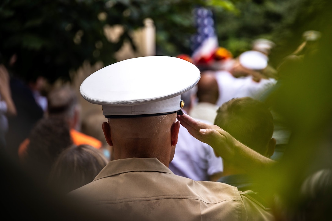 U.S. service members salute during the playing of the national anthem at the time of the fallen five memorial ceremony at the Wreath of Honor Fallen Five Memorial Park, Chattanooga, Tennessee, July 16th, 2025. The Wreath of Honor Fallen Five Memorial honors the loss of five U.S. service members tragically killed July 16th, 2015, in a terrorist attack in Chattanooga, today, marking the 10-year anniversary and the vivid memory of their sacrifice. (U.S. Marine Corps photo by Lance Cpl. Edward Spears)