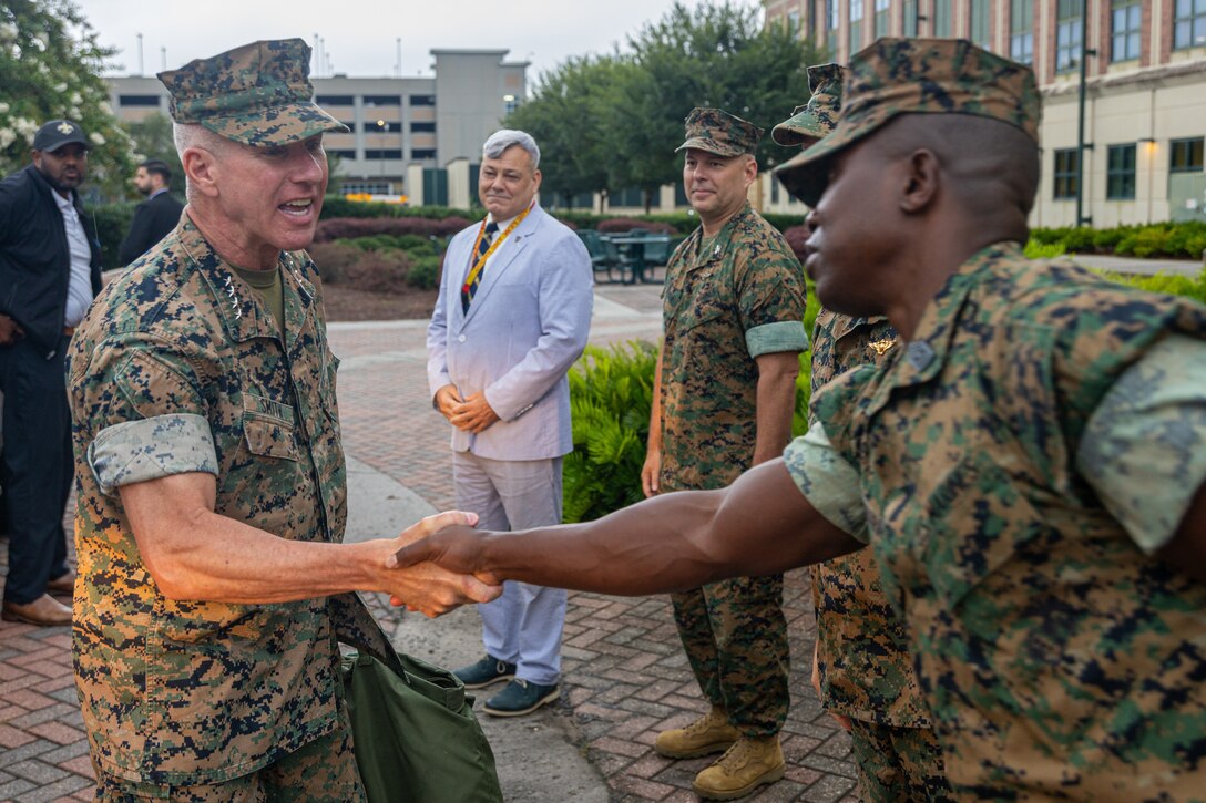 The 39th Commandant of the Marine Corps, Gen. Eric Smith, greets Sgt. Maj. Kabiru M. Labaran, sergeant major of Headquarters Battalion, Marine Forces Reserve and Marine Forces South, upon his arrival at the Marine Corps Support Facility New Orleans, July 17, 2025. Smith visited New Orleans to recognize the Marines and staff who dedicate their time and efforts to support the MARFORRES and MARFORSOUTH missions. (U.S. Marine Corps photo by Cpl. Aaron TorresLemus)