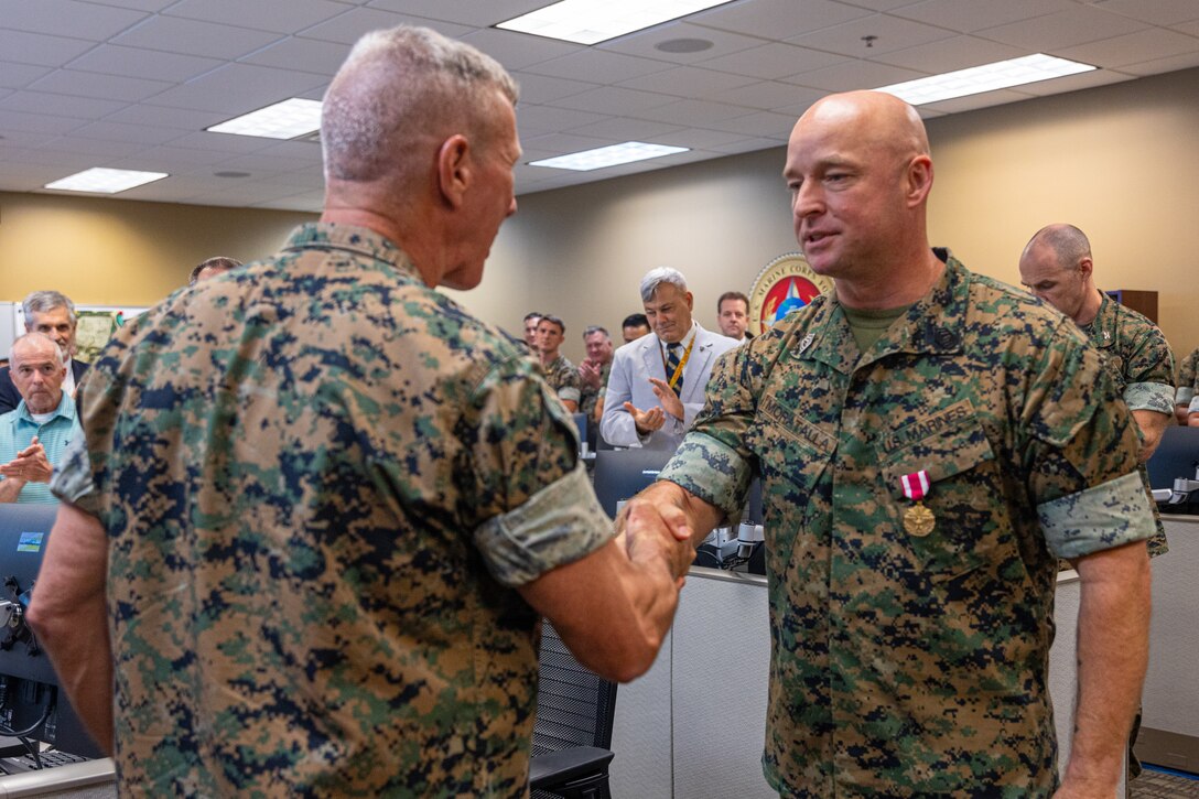The 39th Commandant of the Marine Corps, Gen. Eric Smith, awards Master Sgt. Andres Moratalla, theater security cooperation operations chief with Marine Forces South, with the Meritorious Service Medal at Marine Corps Support Facility New Orleans, July 17, 2025. Gen. Eric Smith visits New Orleans to recognize the Marines and staff who dedicate their time and efforts to support the MARFORRES and MARFORSOUTH missions. (U.S. Marine Corps photo by Cpl. Aaron TorresLemus)